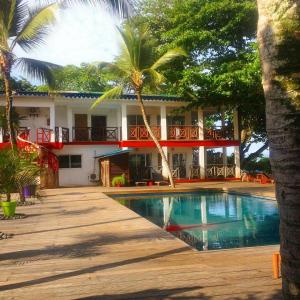 a house with a swimming pool in front of it at Hôtel du Phare in Kribi