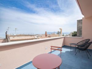 a room with a balcony with a table and chairs at Piricù Apartments in Castellammare del Golfo