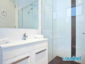 a bathroom with a white sink and a shower at Block Escape No 5 - Penthouse Balcony Wi-fi in Victor Harbor
