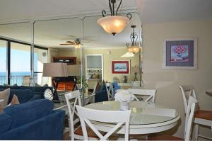 a living room with a table and a blue couch at One Seagrove Place 0908 in Santa Rosa Beach
