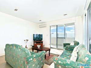 a living room with two chairs and a television at The Block Escape - Ocean Views No 6 in Victor Harbor