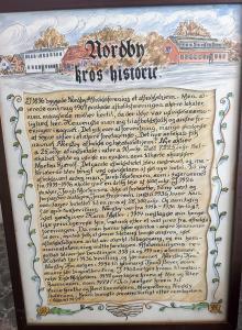 a handwritten document with a picture of a town at Nordby Kro in Nordby