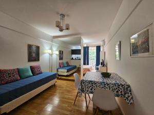 a living room with a blue couch and a table at Recoleta Beatiful Apartment III in Buenos Aires