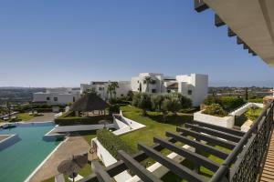 a view from the balcony of a resort with a swimming pool at Tranquil 2-bed apt Alanda Flamingos in Estepona