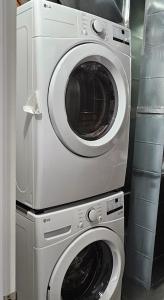 a washing machine and a dryer in a room at Feel At Home in Edmonton