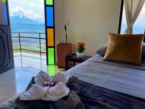 a bedroom with a bed with a flower on it at Hotel Turístico El Cedral in Socorro