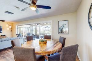 a dining room with a wooden table and chairs at Sunny Side Up in Cape Coral +27 photos