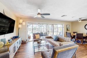 a living room with a couch and a flat screen tv at Caloosahatchee Independence in Cape Coral
