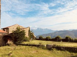 a house in a field with mountains in the background at Lover's Nest by Holiday World in Baiardo +10 photos