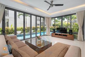 a living room with a couch and a television at Ocean Beach Resort Da Nang in Danang