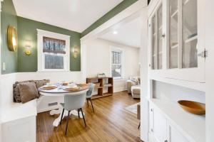 a kitchen and living room with a table and chairs at Historic family getaway mins from downtown in Birmingham