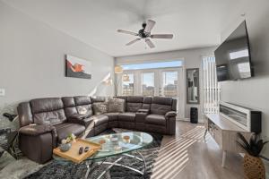 a living room with a leather couch and a table at Relaxstay - Private Spacious 1br Apartment near Galleria Dallas in Dallas
