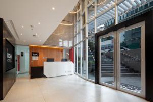 an office lobby with a white reception desk in a building at Ikonik Miraflores in Lima