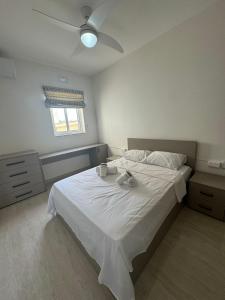 a bedroom with a bed with two towels on it at Victoria Modern Apartment in Victoria