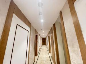 a corridor in a building with a ceiling at HOTEL SARC ! VARANASI - Forɘigner's Choice ! fully Air-Conditioned hotel with Lift & Parking availability, near Kashi Vishwanath Temple, and Ganga ghat 2 in Varanasi