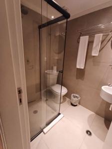 a bathroom with a shower and a toilet and a sink at Hotel Bella Paulista in Sao Paulo