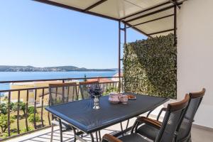 una mesa en un balcón con vistas al agua en Apartments Villa Ivanka, en Trogir