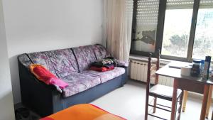 a purple couch in a room with a table at 2 bedrooms apartement with city view and wifi at Oviedo in Oviedo