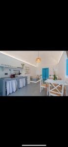 a kitchen with a table and a dining room at Medusa traditional house in Emporio