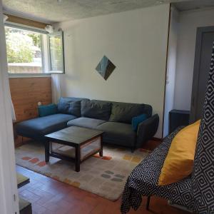 a living room with a couch and a coffee table at Le temps d'une escale in Le Tampon