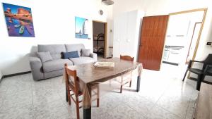 a living room with a table and a couch at Economy Guest House in Gallipoli
