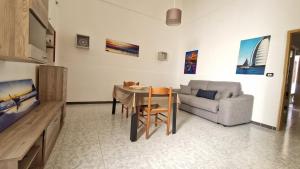 a living room with a table and a couch at Economy Guest House in Gallipoli