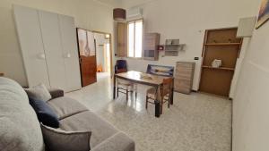 a living room with a couch and a table at Economy Guest House in Gallipoli