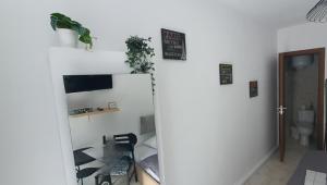 a room with a white wall and a mirror at St.Barbara studio in Drama +6 photos