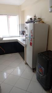 a kitchen with a white refrigerator and a sink at اقامة السعادة ادرار in Agadir