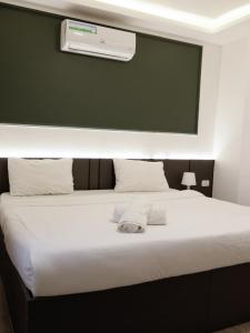 a bedroom with a large bed with a air conditioner at privet (35)near downtown JRE in Amman