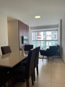 a dining room with a table and chairs at ITAPARICA BEACH CLUB in Vila Velha