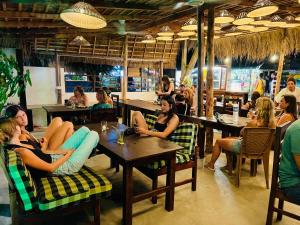 a group of people sitting at tables in a restaurant at Arcadia villas Arugambay in Arugam Bay
