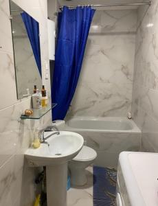 a bathroom with a sink and a toilet and a tub at Елисаветинская 15 in Odesa