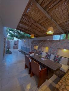 a dining room with a wooden table and chairs at Lighthouse Apartment in Dahab