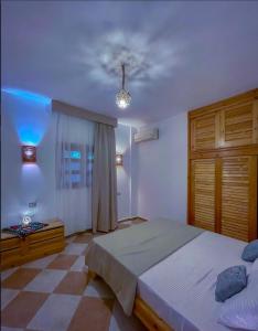 a bedroom with a bed and a ceiling at Lighthouse Apartment in Dahab