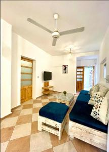 a living room with a bed and a tv at Lighthouse Apartment in Dahab