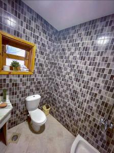 a bathroom with a toilet and a sink at Lighthouse Apartment in Dahab