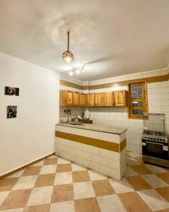 an empty kitchen with a sink and a stove at Lighthouse Apartment in Dahab