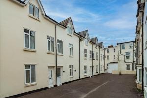 a row of white buildings in a street at south view in Bournemouth