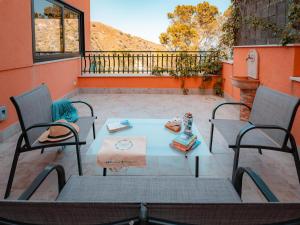 a patio with a table and chairs on a patio at Pascià Madonna Rocca in Taormina