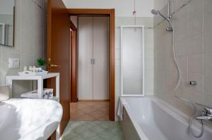 a bathroom with a bath tub and a sink at Lake Como Getaway - Central, Lake nearby - Parking & private garden in Mandello del Lario +24 photos
