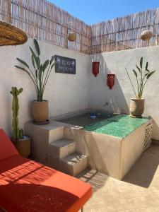 uma piscina num pátio com vasos de plantas em Magnifique Riad Privatif Kasbah em Marrakech