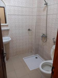 a bathroom with a shower and a toilet at fleur in Dakar