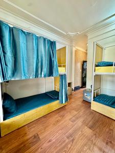 two bunk beds in a room with wooden floors at Old Quarter Autumn To Tich Ha Noi in Hanoi