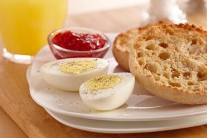 a white plate with eggs and bread on a table at TownePlace Suites Gaithersburg in Gaithersburg