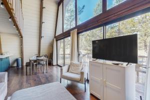 a living room with a large flat screen tv at Sunshine in Sunriver in Sunriver