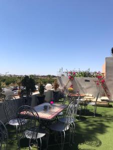 a group of tables and chairs on a roof at Winarouze house in Marrakech