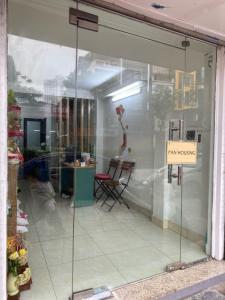 a window of a store with a sign in it at Pan Housing Hostel & Residence in Hanoi