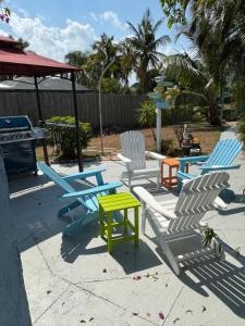 a group of chairs and a table and a stove at Little Piece Of Heaven, on the river in River Park