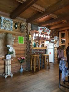 a kitchen and dining room of a log cabin at Barbu Ionel in Băile Herculane
